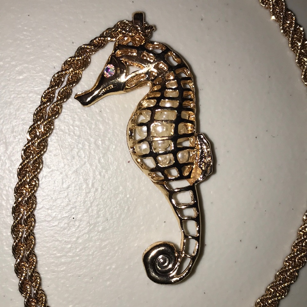 NWOT Beautiful sea horse necklace with white beads inside.